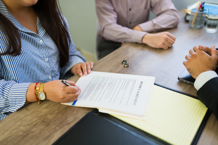 couple signing divorce papers in law office
